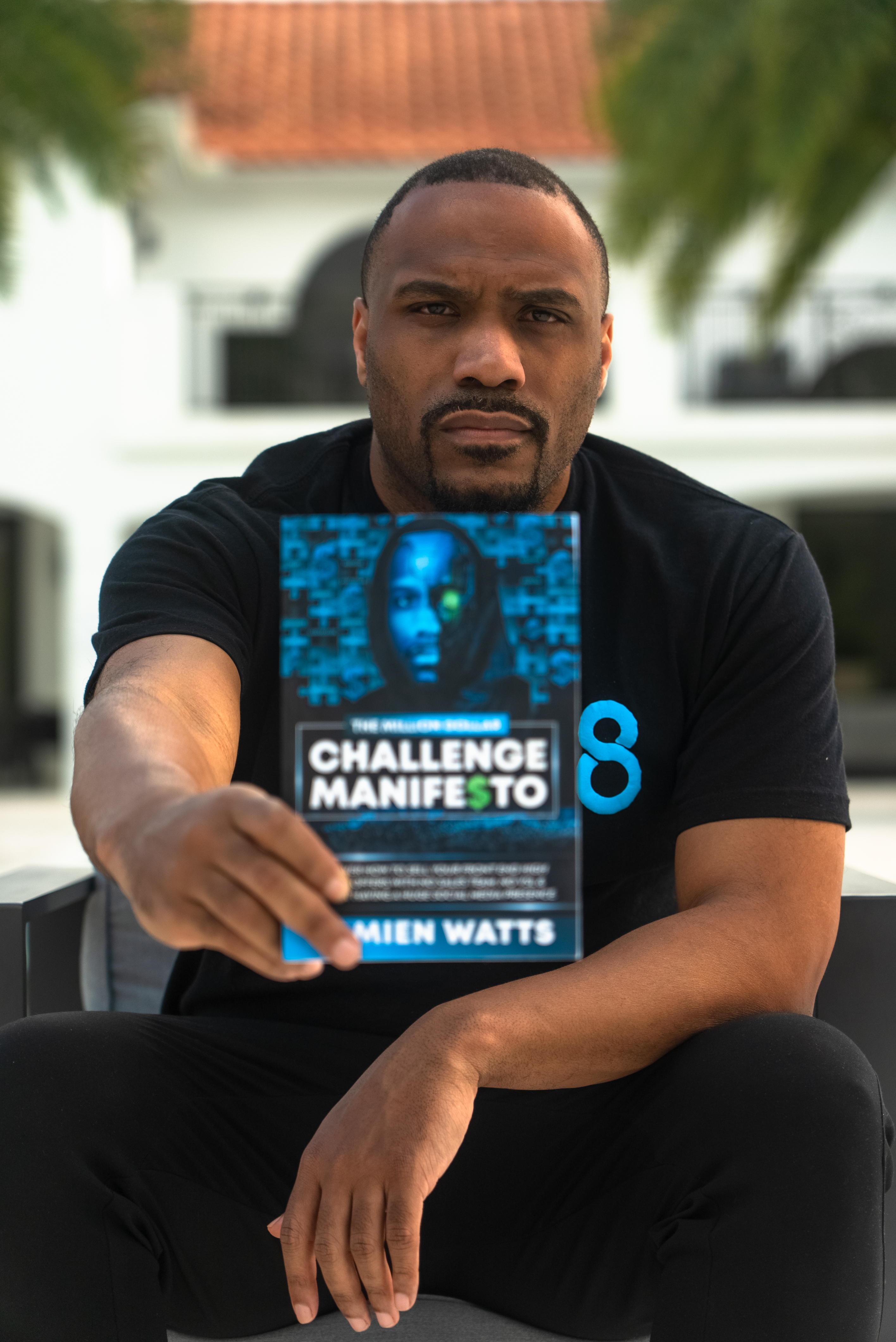 Damien Watts holding The Million Dollar Challenge Manifesto