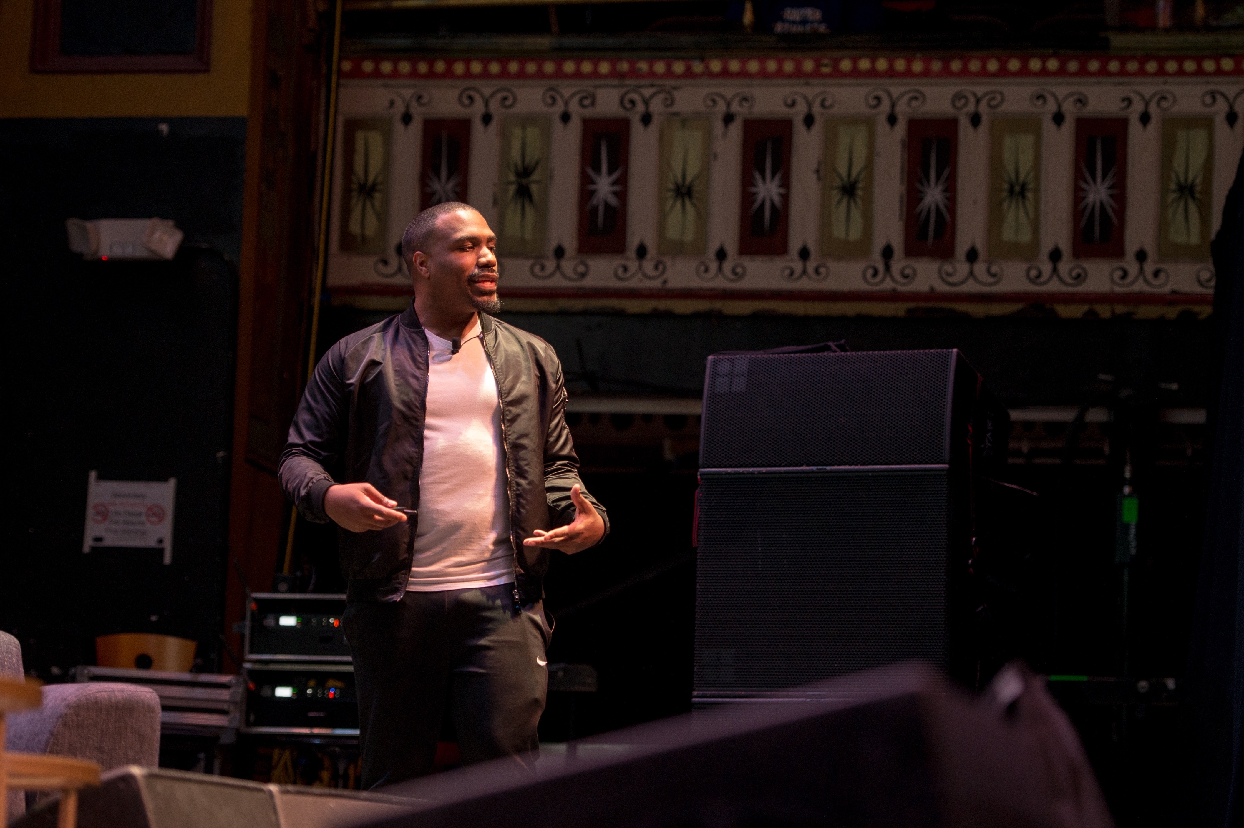 Damien on stage at a historic theater venue